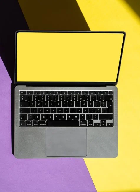 A stylish workspace featuring a laptop and monitors displaying design software.