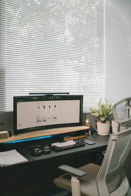 Create the website of your dreams for what lies ahead. A laptop, MacBook, resting on a portable table with a coffee tea mug beside it.